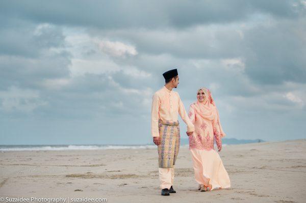 bride groom walking holding hand beach cloud