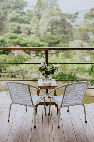 chair with flowers on table facing lake