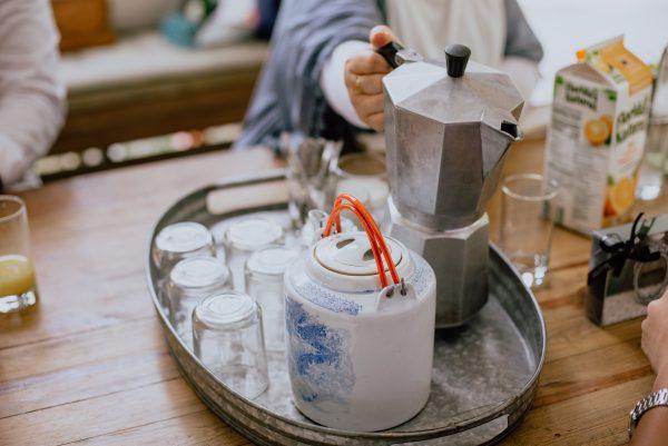 holding tea pot and coffee pot